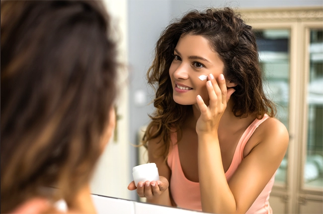 Woman applying skincare cream